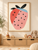 Grafische Aardbei Roze in een houten lijst boven een speelgoedkast in een lichte kinderkamer