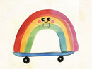 Een glimlachende regenboog in rood, roze, oranje, geel, groen en blauw op een blauw skateboard met zwarte wielen.